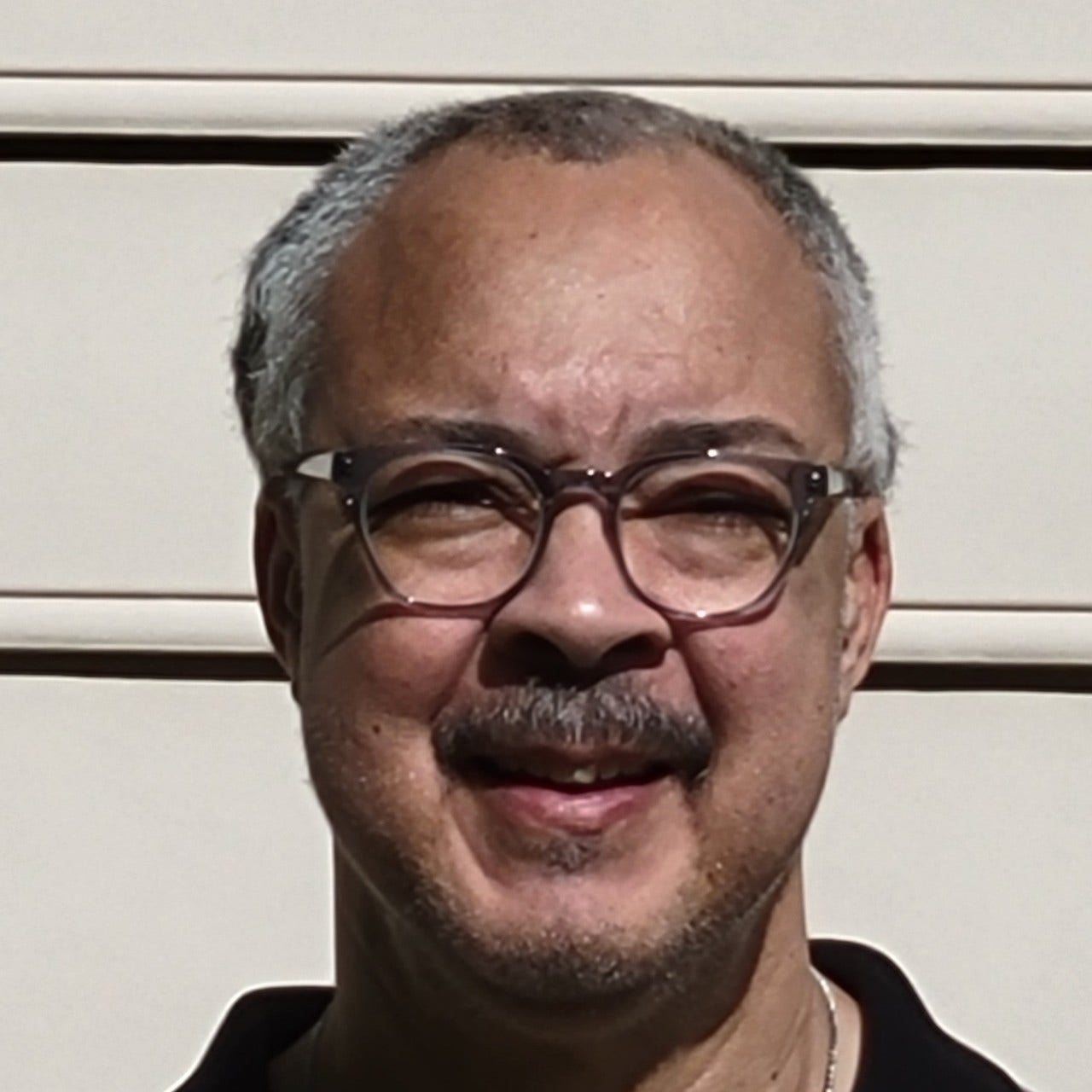 white man with glasses and moustache with light beard