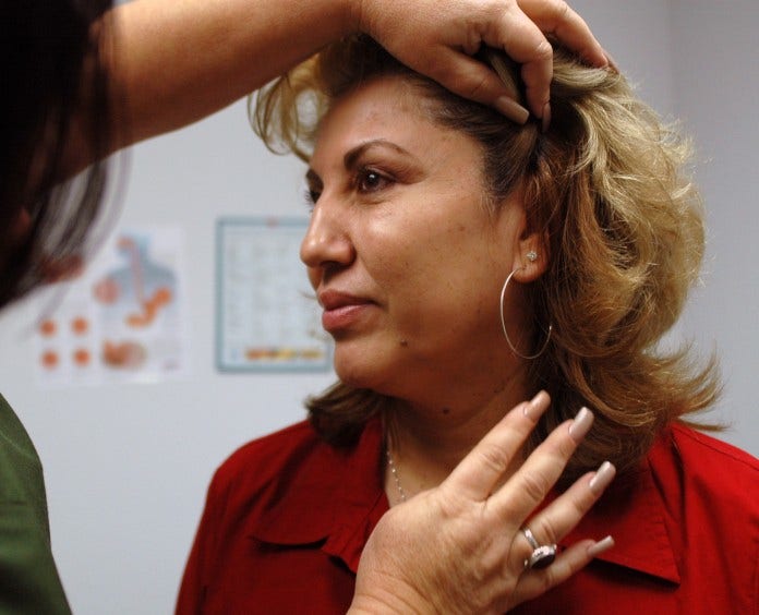 woman getting a skin exam from doctor