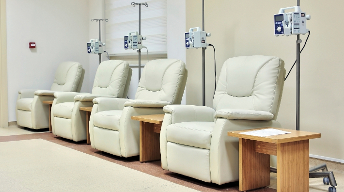 line of empty chairs in chemotherapy room