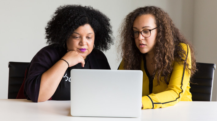two women looking at laptop screen