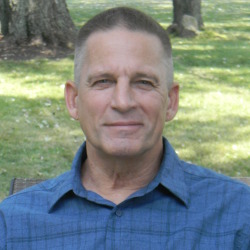 cancer survivor, John Christman, sitting outside