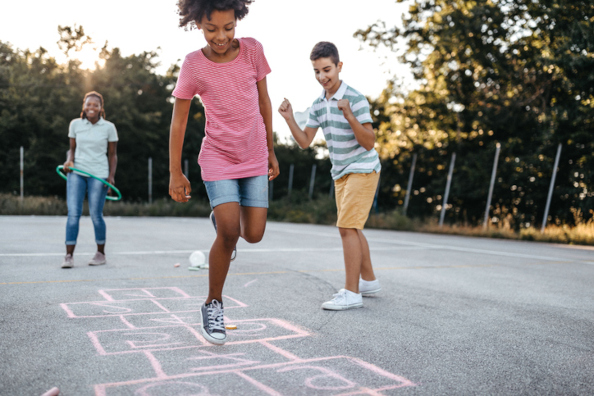 Three Kids Playing Hopscotch