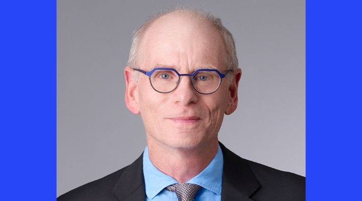 William L. Dahut, MD Chief Scientific Officer wears blue rimmed glasses in a headshot