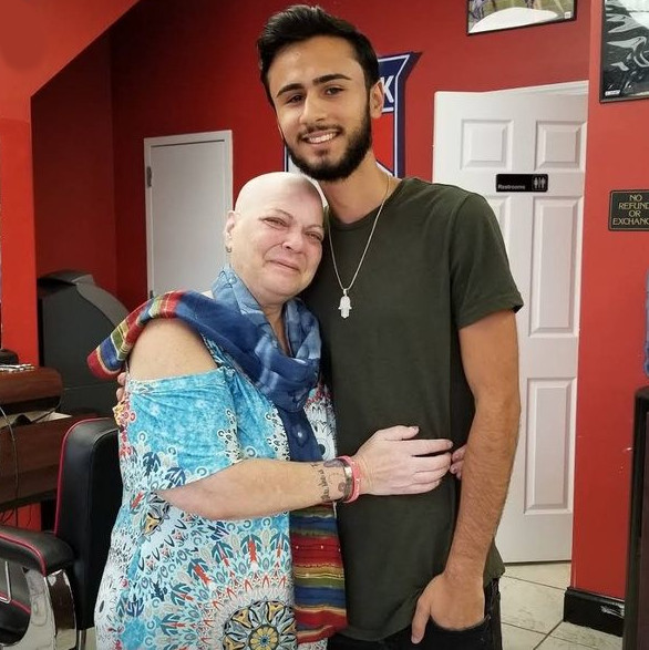 cancer survivor, Phyllis Alsterberg, with her barber after he shaved her head