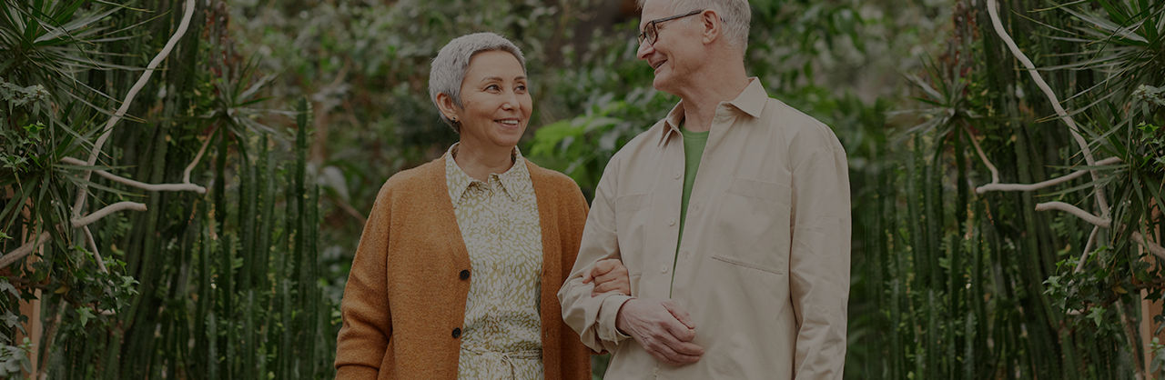 male and female holding arms amongst the trees