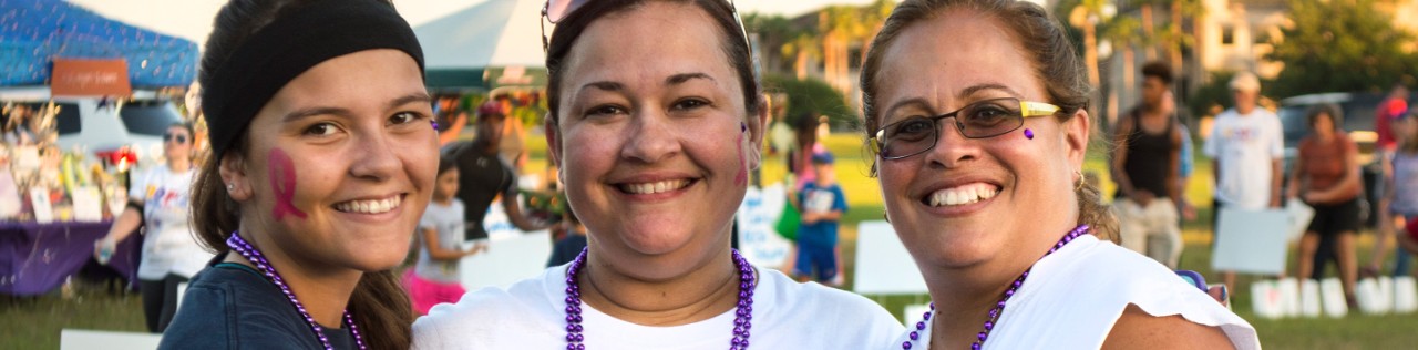 Three multi generational Hispanic women at an event outdoors