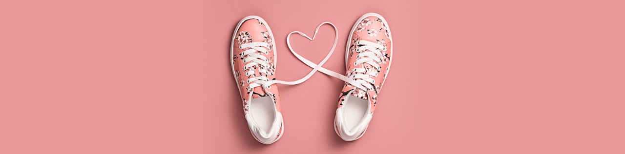 pair of pink shoes with a heart made from shoestrings