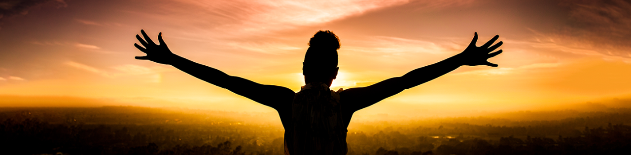 black woman silhouette with arms stretched out 