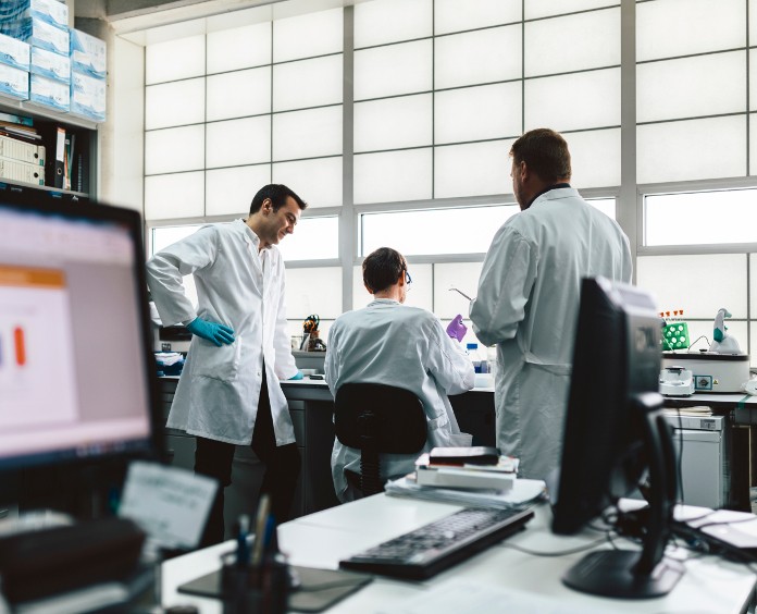 three researchers work in lab 
