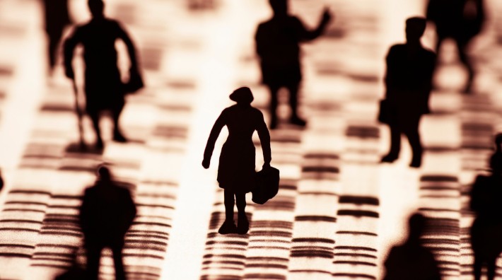 silhouettes of people standing on a DNA profile, focusing on the silhouette of a woman