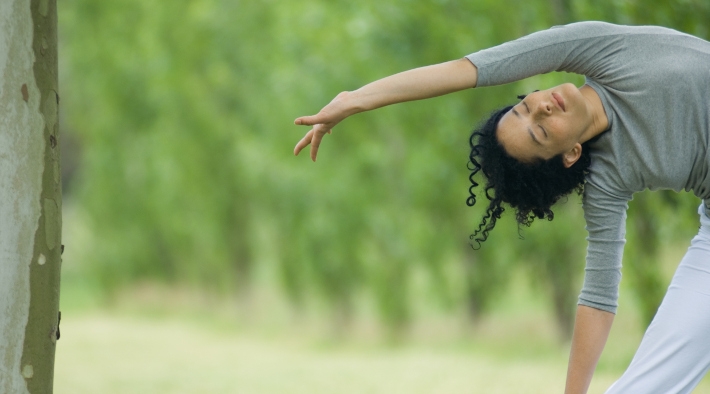 woman does side bends outside