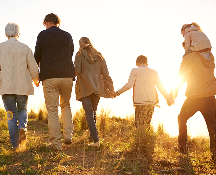 Family holding hands on a morning walk together