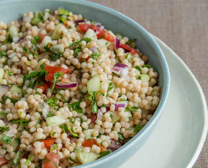 close up of a bowl of pearl couscous "tabbouleh" 