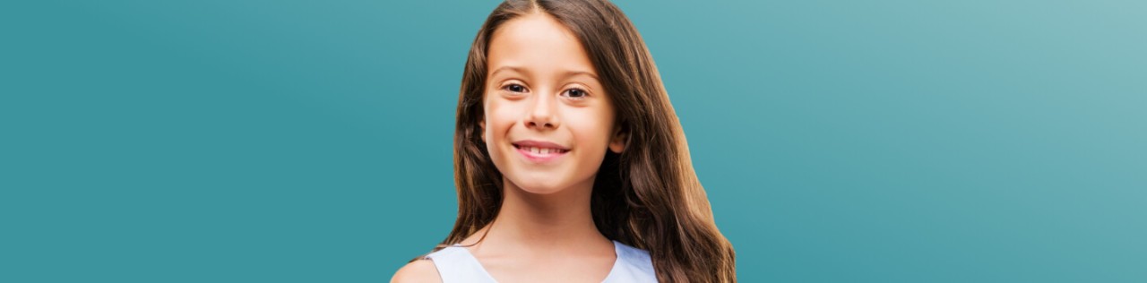 Caucasian girl with long hair smiling fin front of a teal background