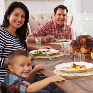happy family eating together at table