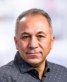 Headshot of Soheil Meshinch, MD, PhD, black shirt with white dots
