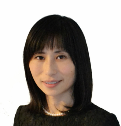 Asian woman with shoulder-length dark hair, wearing pearls and black top