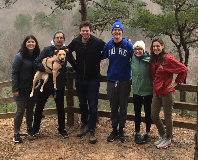 Dorothy Sipkins, MD, PhD and her lab team hiking in Hillsborough, NC.:  Sarah Ridge, PhD, Trevor Price, PhD (holding their mascot, Eleanor), Andrew Murray, PhD, Andy Whiteley, Kathleen Marsh, and Sipkins.  