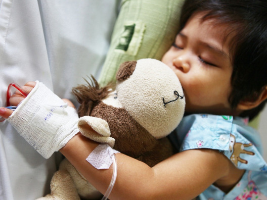 Asian Baby Holding Stuffed Animal with IV
