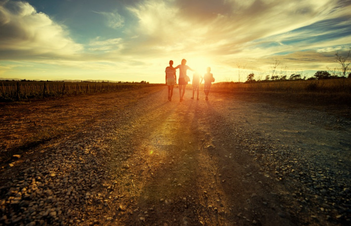 Family Walking Into Sunset