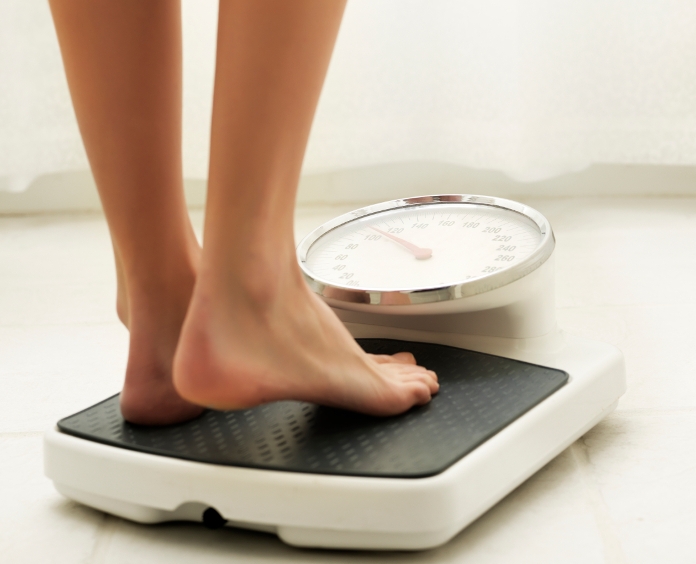 close up of a woman's feet on bathroom scales