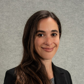 young Black woman with long hair gray sweater with white pointed collar