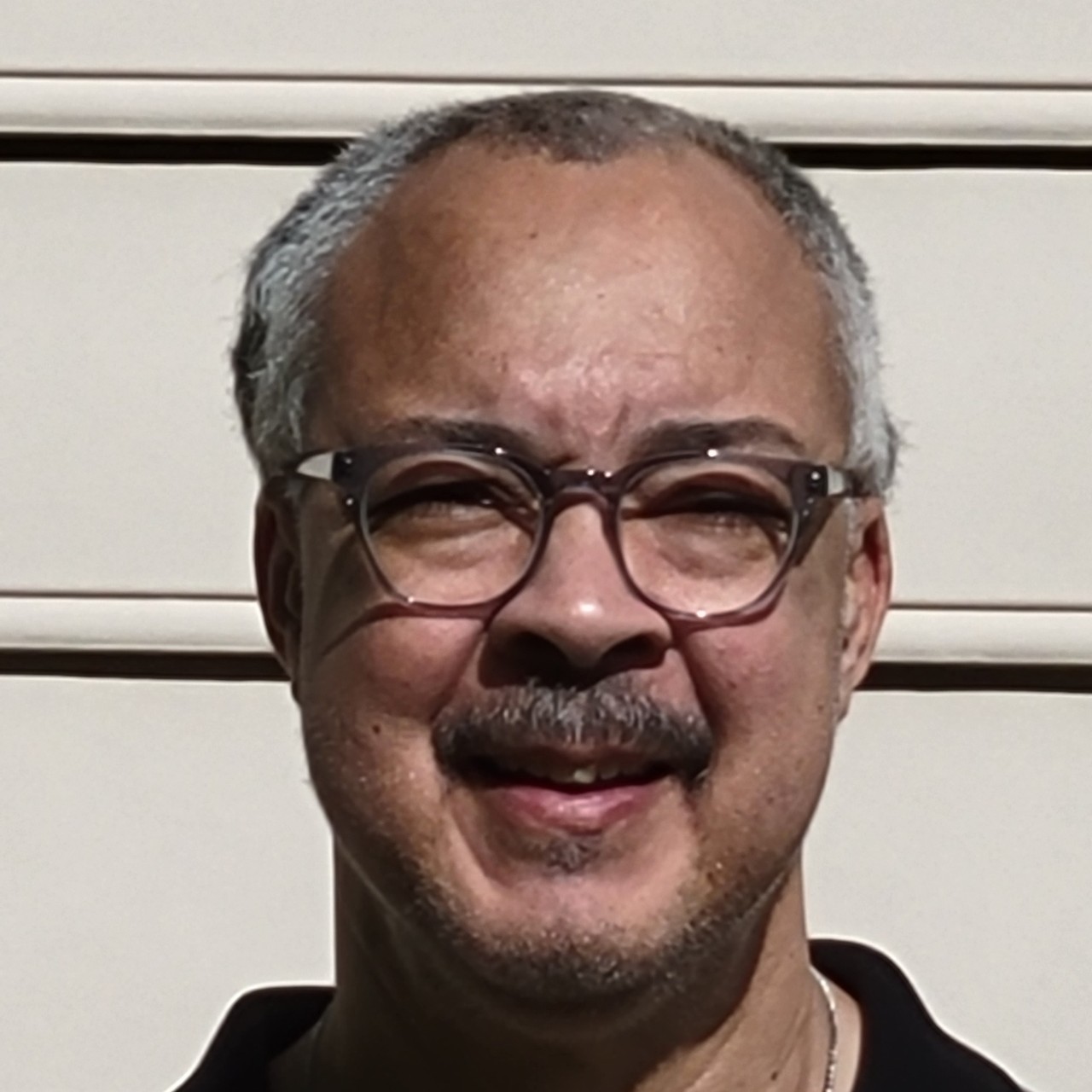 white man with glasses and moustache with light beard