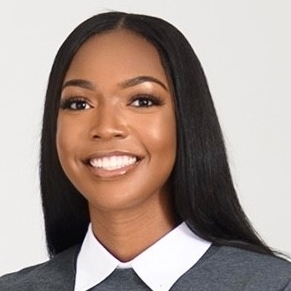 young Black woman with long hair gray sweater with white pointed collar